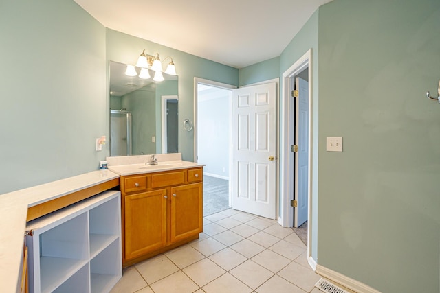 full bath featuring a stall shower, tile patterned flooring, vanity, and baseboards