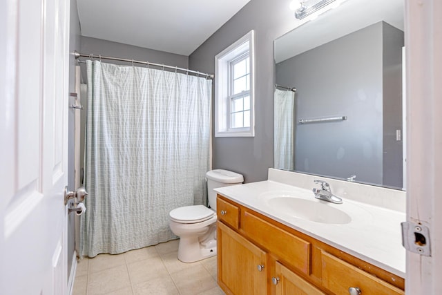 full bathroom with vanity, toilet, and tile patterned floors