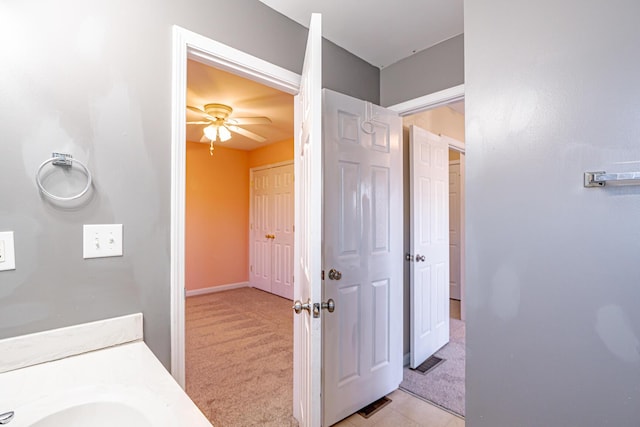 bathroom with ceiling fan and a sink