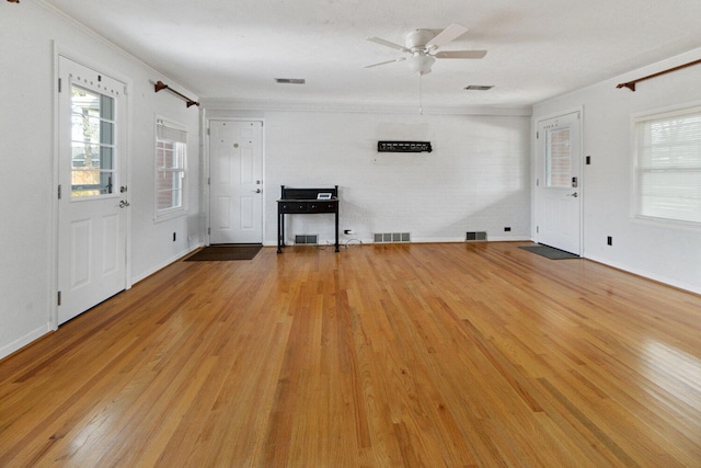 unfurnished living room featuring visible vents and light wood-style floors