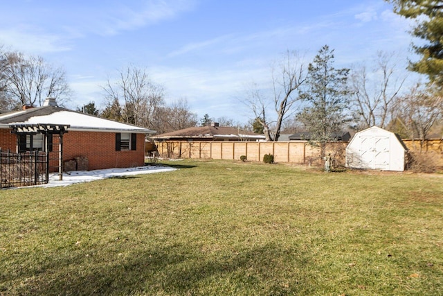 view of yard featuring a patio, a storage unit, an outdoor structure, and fence