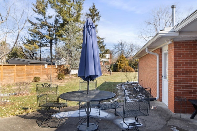 view of patio with outdoor dining area and fence