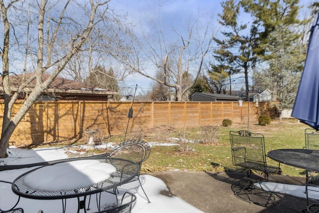 view of yard with a patio area, outdoor dining area, and a fenced backyard