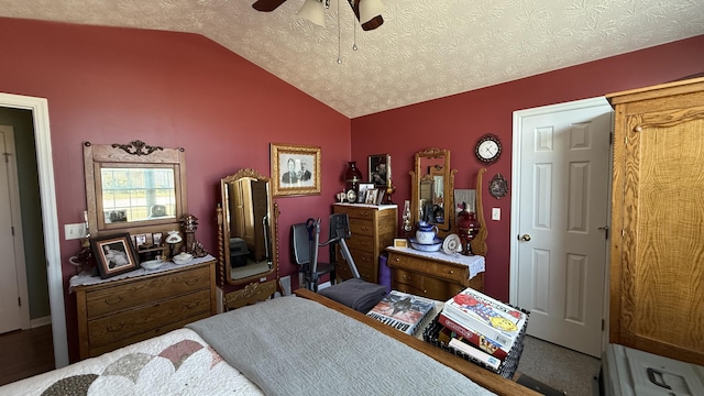 bedroom featuring ceiling fan, vaulted ceiling, and a textured ceiling