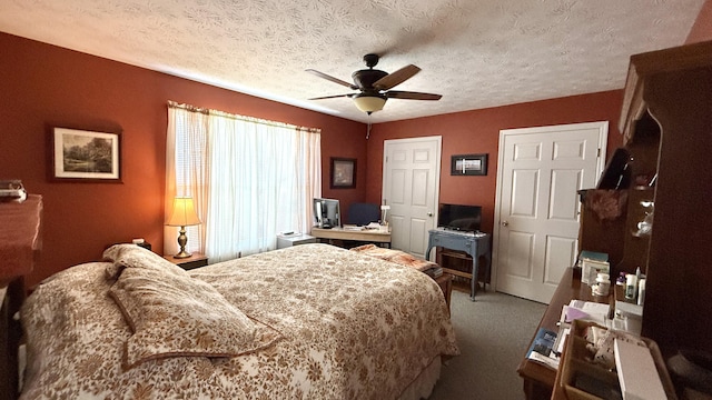 carpeted bedroom featuring ceiling fan and a textured ceiling