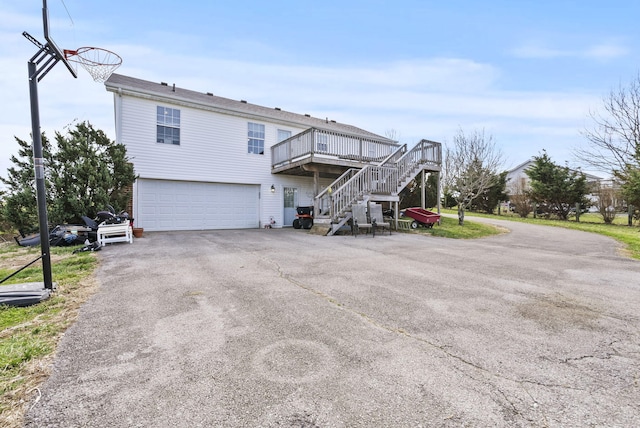 136 Country Ln, Lancaster, KY 40444 - back of property featuring stairway, an attached garage, asphalt driveway, and a wooden deck
