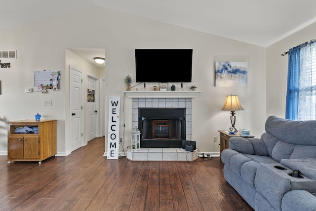 136 Country Ln, Lancaster, KY 40444 - living area featuring vaulted ceiling, dark wood finished floors, a tile fireplace, and baseboards