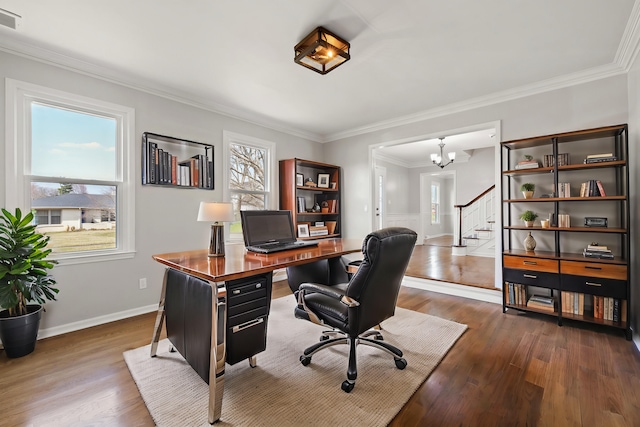 office featuring a chandelier, dark wood-style floors, a healthy amount of sunlight, and ornamental molding