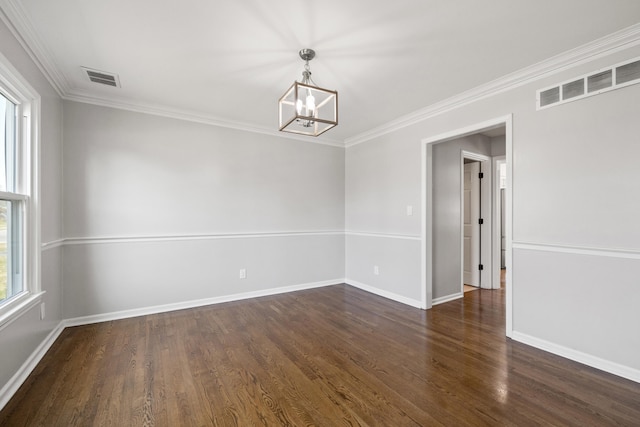 unfurnished room featuring visible vents, wood finished floors, a chandelier, and ornamental molding