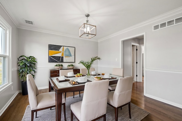 dining area featuring visible vents, dark wood-type flooring, a notable chandelier, and baseboards