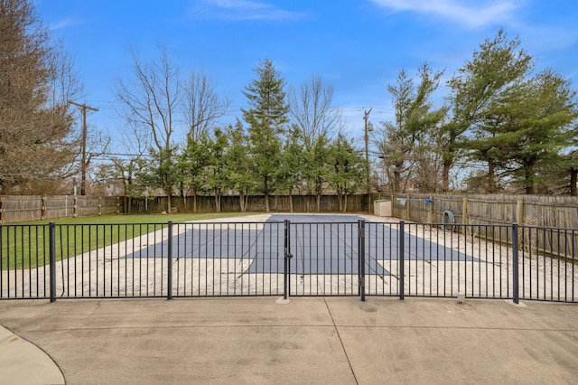 view of swimming pool with a fenced in pool, a yard, a fenced backyard, and a patio area