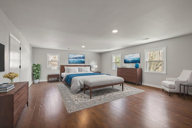 bedroom with hardwood / wood-style floors, recessed lighting, baseboards, and visible vents