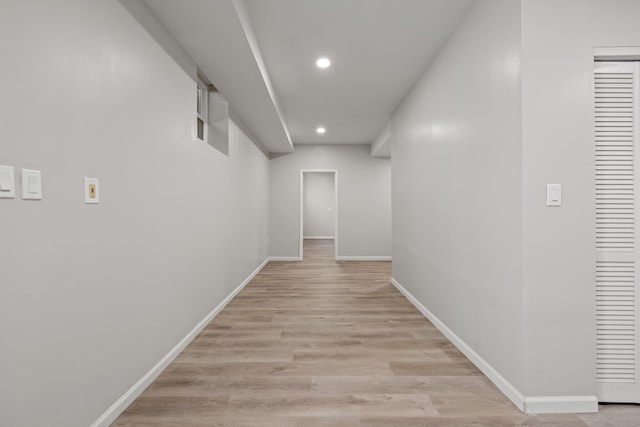 hall featuring recessed lighting, baseboards, and light wood-style floors