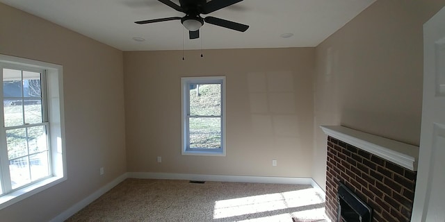 unfurnished living room with baseboards, ceiling fan, carpet flooring, and a healthy amount of sunlight