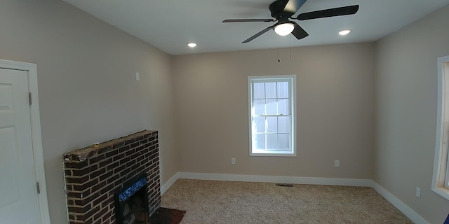 unfurnished living room with ceiling fan, recessed lighting, a fireplace, baseboards, and carpet