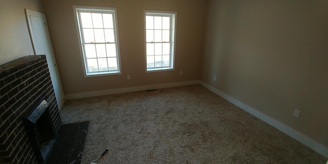 unfurnished living room with carpet floors and baseboards