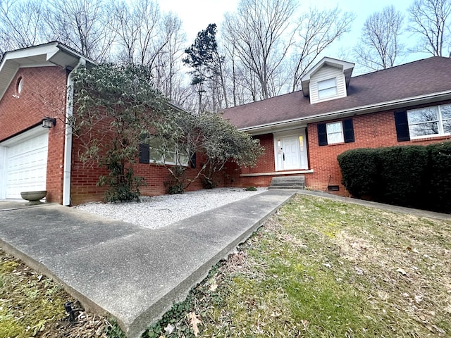 view of front of house featuring a garage, a shingled roof, and brick siding