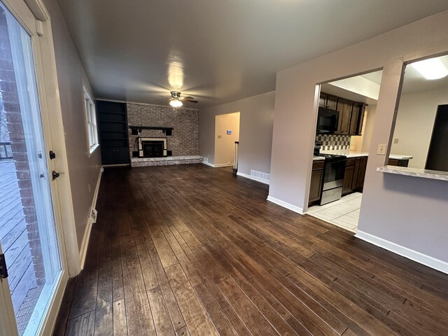 interior details featuring built in shelves, visible vents, baseboards, and wood finished floors