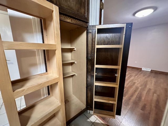 spacious closet featuring visible vents and wood finished floors