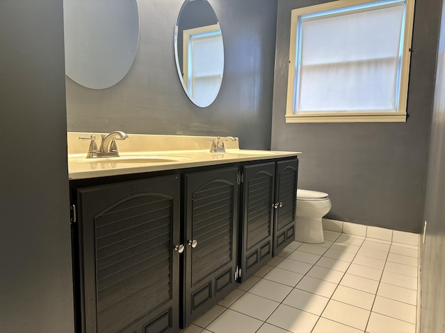 full bathroom with tile patterned flooring, a sink, toilet, and double vanity