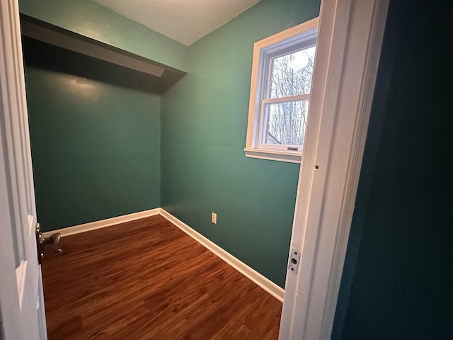 unfurnished room featuring wood finished floors and baseboards