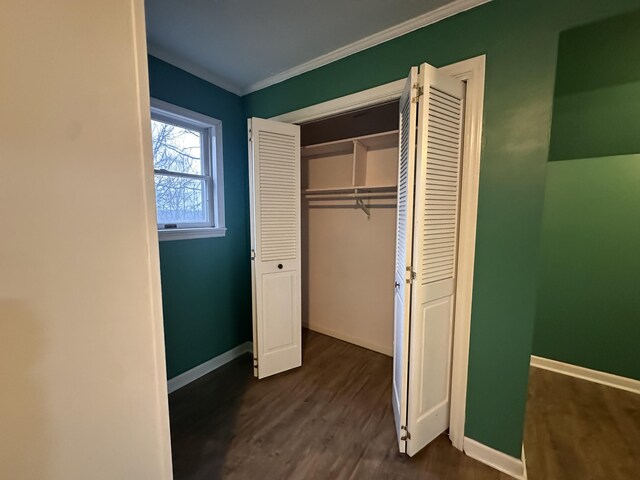 unfurnished bedroom featuring a textured ceiling, wood finished floors, visible vents, baseboards, and a closet