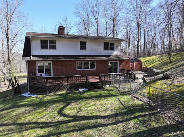 wooden deck featuring a lawn and fence