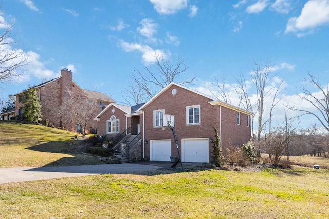 view of front of property with brick siding, a garage, driveway, a front lawn, and stairs