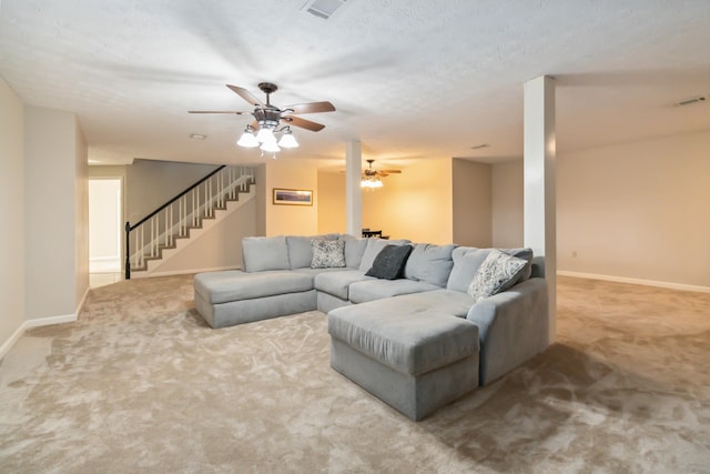 living area featuring carpet flooring, visible vents, stairway, and baseboards