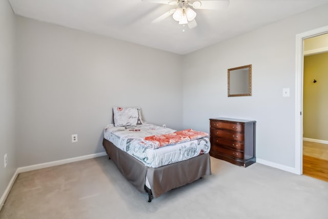 carpeted bedroom with baseboards and a ceiling fan