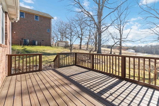 wooden deck featuring central AC and a yard