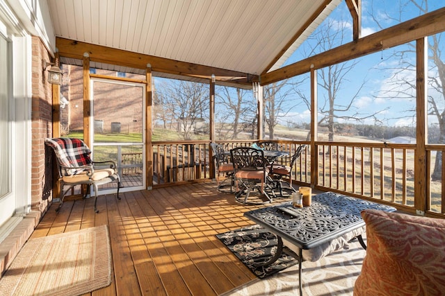 sunroom with lofted ceiling and plenty of natural light