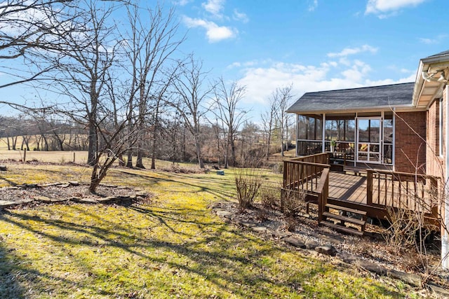 view of yard featuring a sunroom and a deck