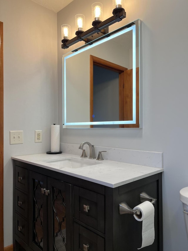 bathroom with toilet and vanity