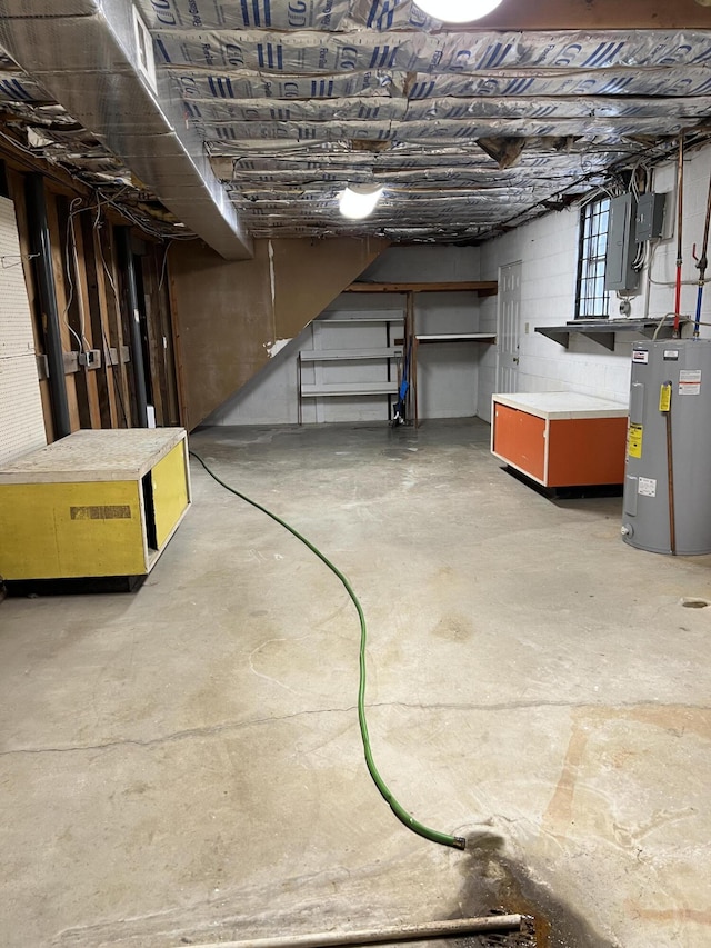 unfinished basement featuring water heater