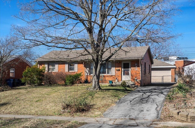 single story home with a garage, driveway, brick siding, and a front yard