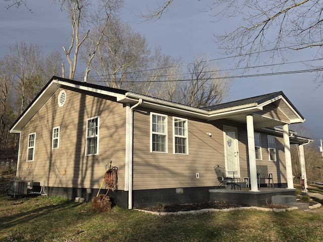 exterior space with crawl space, a patio area, central AC, and a yard