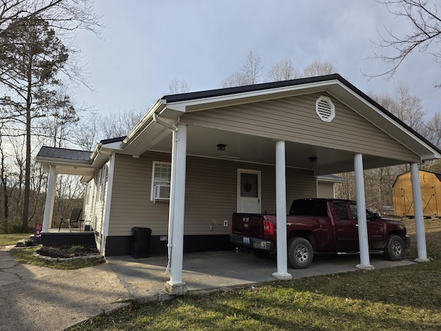 view of parking featuring a carport and a storage unit