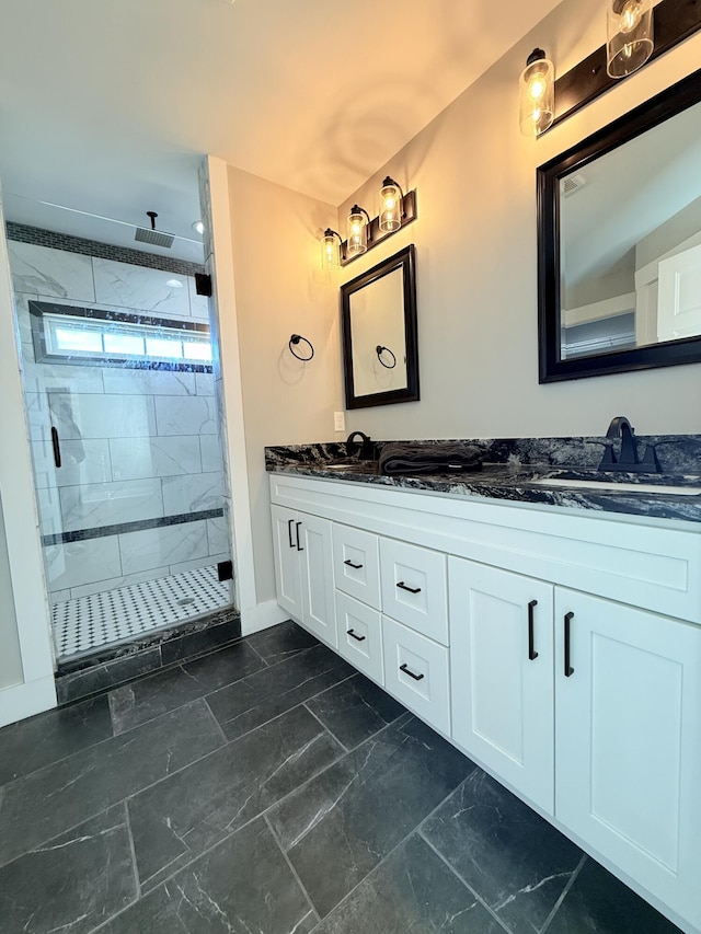 full bathroom featuring a stall shower, marble finish floor, a sink, and double vanity