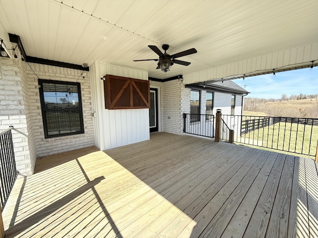 wooden terrace featuring a ceiling fan