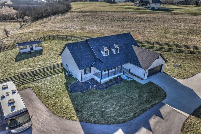 birds eye view of property with a rural view