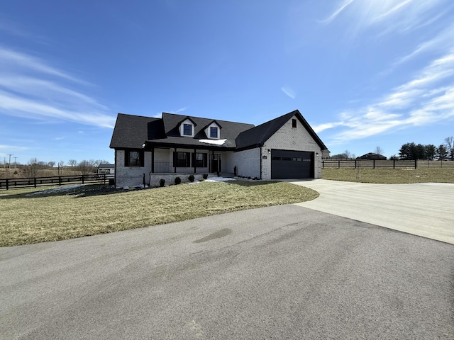 view of front of property with a garage, concrete driveway, fence, and a front lawn