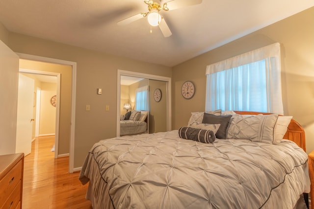 bedroom featuring baseboards, a closet, a ceiling fan, and light wood-style floors