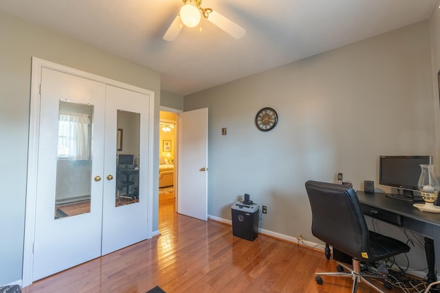 office with baseboards, a ceiling fan, wood finished floors, and french doors