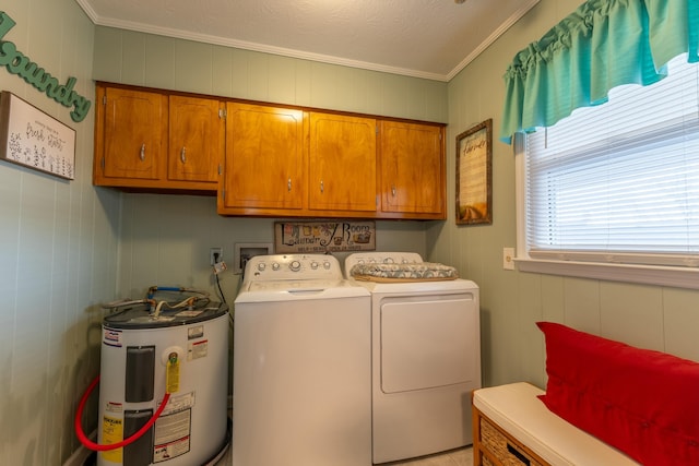 laundry area with cabinet space, washing machine and clothes dryer, crown molding, and electric water heater