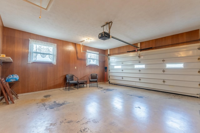 garage featuring wood walls and a garage door opener