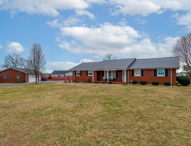 ranch-style house with a front yard, brick siding, and metal roof