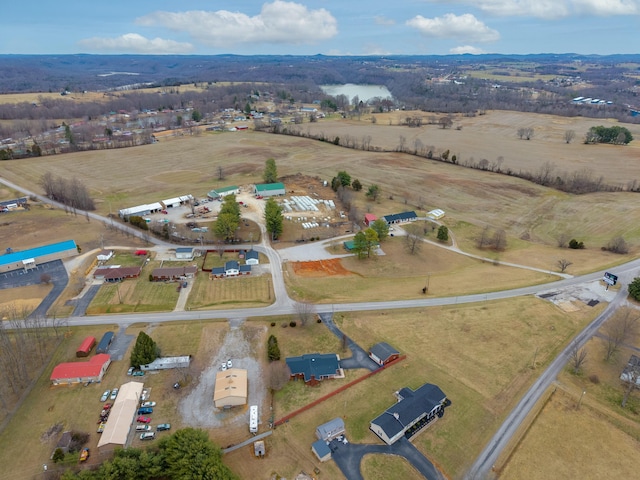 birds eye view of property featuring a water view and a rural view