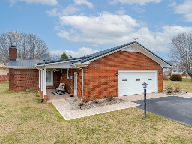 view of home's exterior with aphalt driveway, a lawn, and brick siding