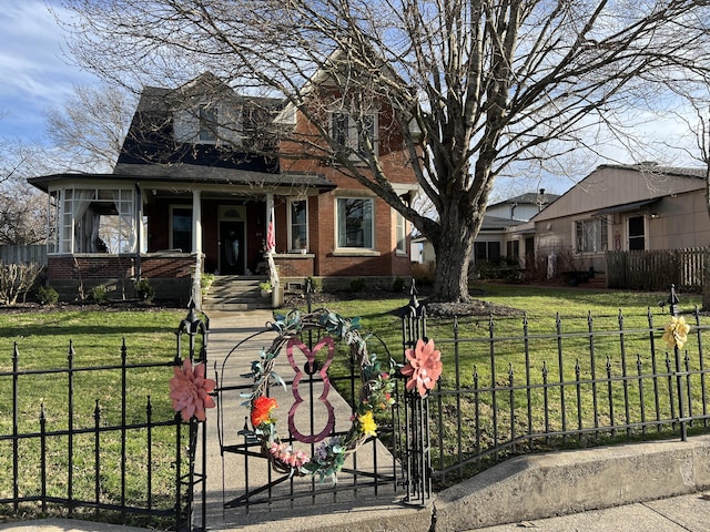 view of front of property with a fenced front yard, brick siding, and a front lawn